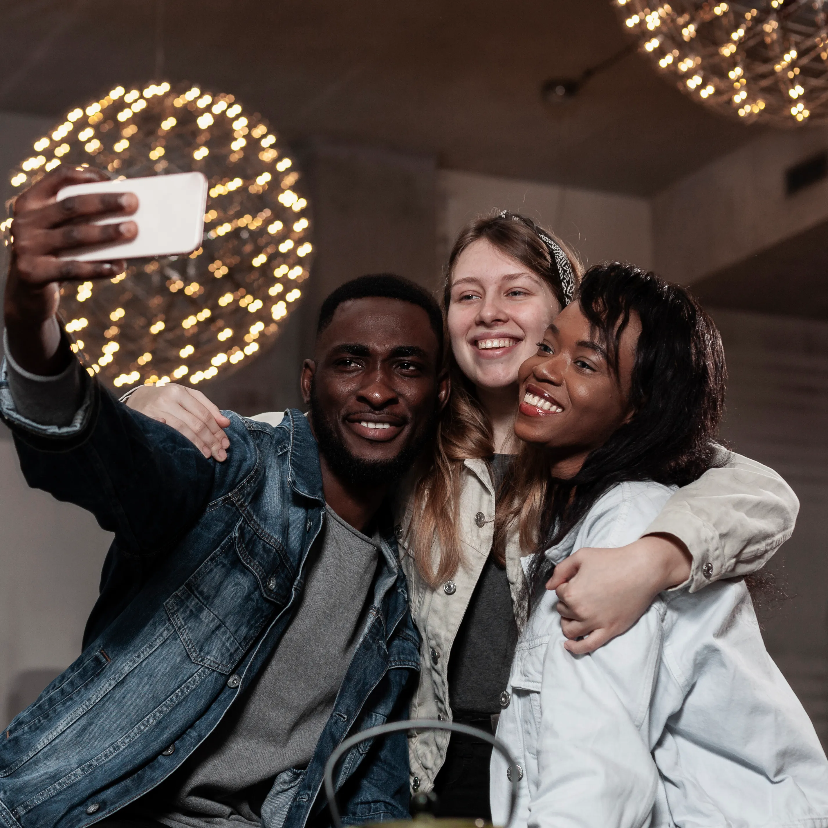 Friends taking photos together at a creator community event, celebrating collaboration and networking